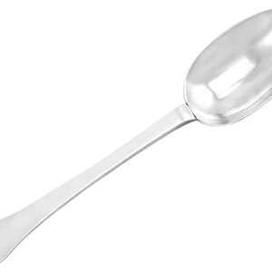 May include: A silver spoon with a rounded bowl and a long, slender handle. The handle has a decorative, scalloped edge.