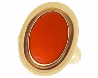 May include: A gold ring with an oval-shaped orange gemstone set in a bezel setting.