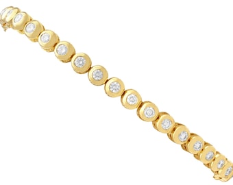 May include: A gold tennis bracelet featuring a continuous row of round, bezel-set clear stones. The design consists of individual circular gold links, each holding a single sparkling stone, connected to form a flexible chain with a secure clasp.
