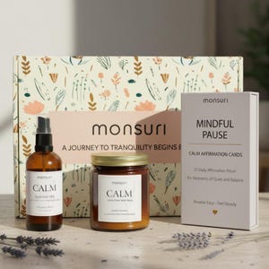 May include: A gift set with a floral patterned box, a spray bottle, a jar candle, and a card deck. The spray bottle and candle have "CALM" labels. The card deck is labeled "MINDFUL PAUSE" and "CALM AFFIRMATION CARDS". The set is designed for relaxation.