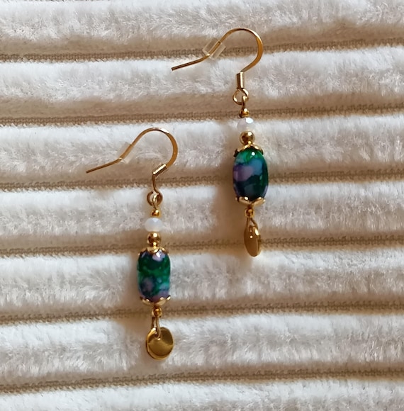 Gold-tone stainless steel sleeper earrings in a boho style with marbled green and purple beads, handcrafted.