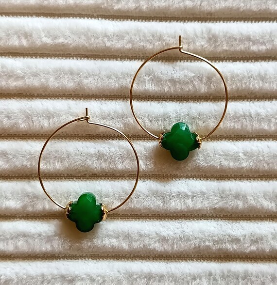Gold or silver hoop earrings. 304l stainless steel, gold or silver color, with green glass clovers and gold trim.