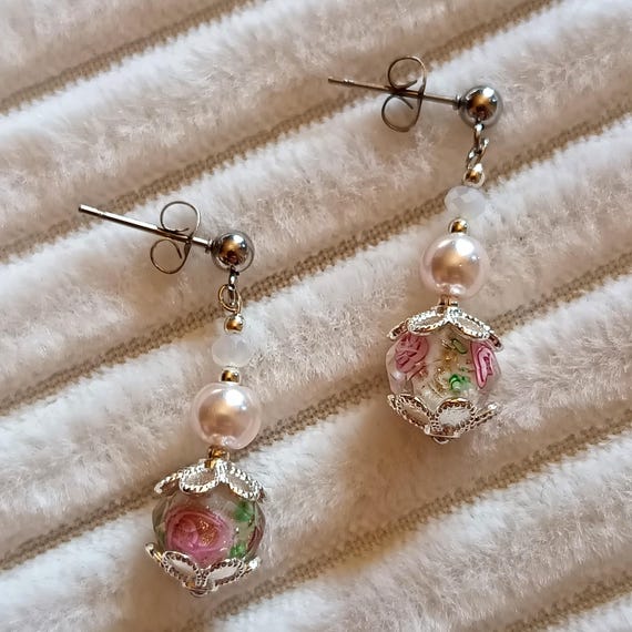 Silver-tone 304L stainless steel earrings with faceted silver beads, pink pearl beads, and pink flower beads.