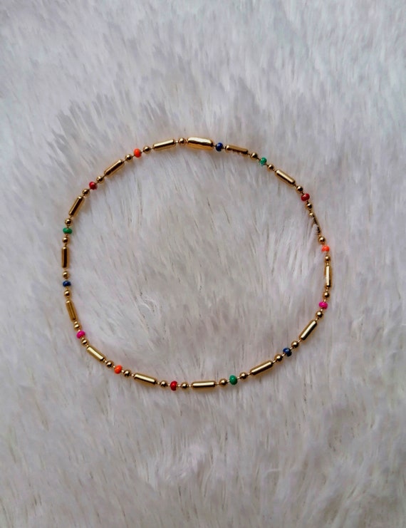 Women's bracelet with gold-tone stainless steel chains, satellite links, and multicolored gold beads. Handmade.