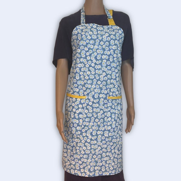 Apron made of Daisy fabric with deep pockets and yellow trim large enough for cell phones, items needed for entertaining or cooking & chores