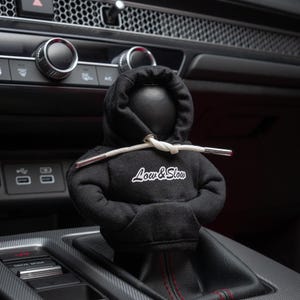 May include: Black hoodie car gear shift knob with white "Low & Slow" text.