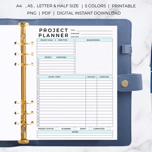 May include: A printable project planner page with sections for project goals, milestones, action steps, and notes. The page is designed for use in a binder with a gold ring mechanism.