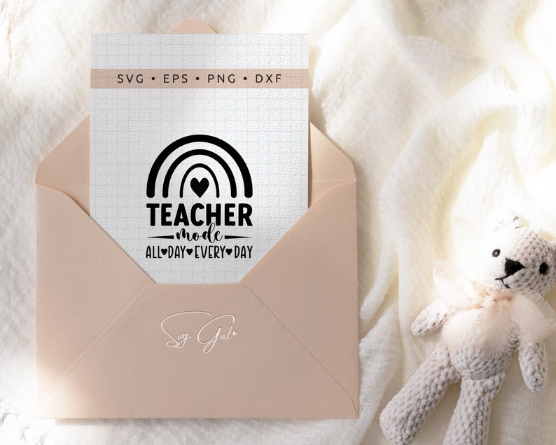 May include: A white card with a black rainbow, heart, and the text "TEACHER mode ALL DAY EVERY DAY". The card is on a pink envelope.