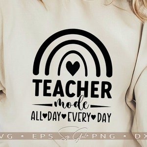 May include: A white sweatshirt with a black rainbow design and the text "Teacher mode all day every day".