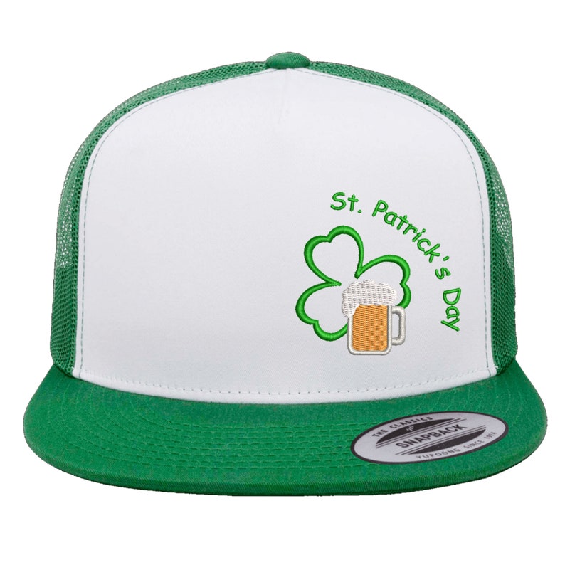 May include: White and green trucker hat with a green shamrock and a beer mug embroidered on the front. The hat says "St. Patrick's Day" in green embroidery.