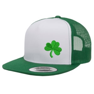 May include: White and green trucker hat with a green shamrock embroidered on the front. The hat has a mesh back and a green brim.