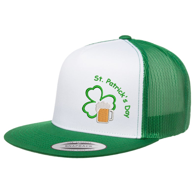 May include: White and green trucker hat with a green shamrock and a beer mug embroidered on the front. The text "St. Patrick's Day" is embroidered on the hat.