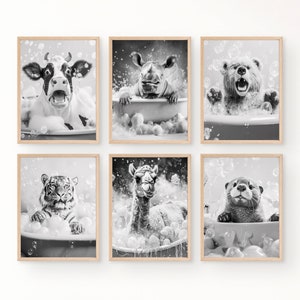 May include: Six framed black and white animal prints. Each print features a different animal, including a cow, rhino, bear, tiger, llama, and otter, all in bathtubs filled with bubbles. The prints have a light wood frame.