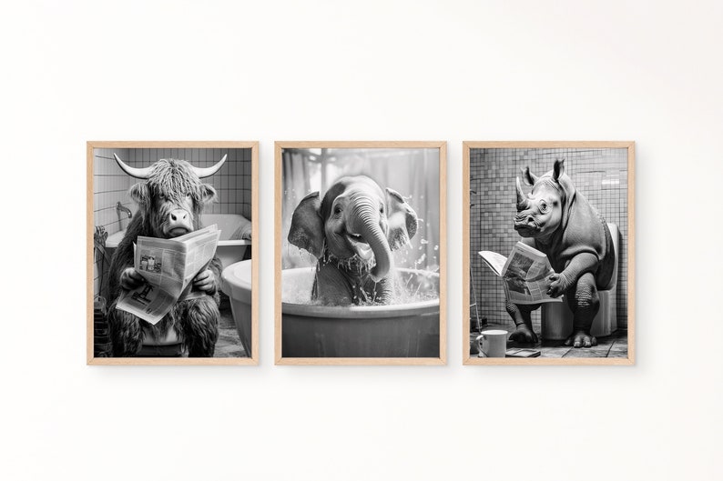 May include: Set of three framed black and white prints. Each print features an animal in a bathroom setting: a Highland cow reading a newspaper in a bathtub, an elephant in a tub, and a rhino on a toilet reading a newspaper.