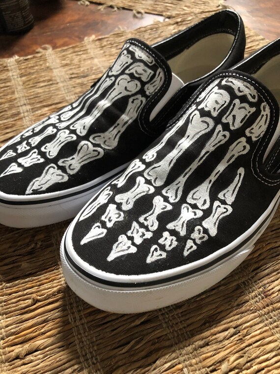 vans skeleton slip ons