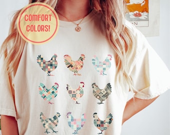 May include: A white t-shirt with a patchwork design of nine chickens in various colors. The text "COMFORT COLORS!" is on a yellow circle in the top left corner of the image.