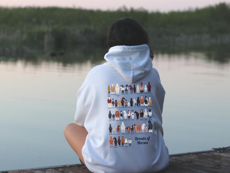 May include: A white hoodie with a graphic of different horse breeds on the back. The text "Breeds of Horses" is printed below the graphic.
