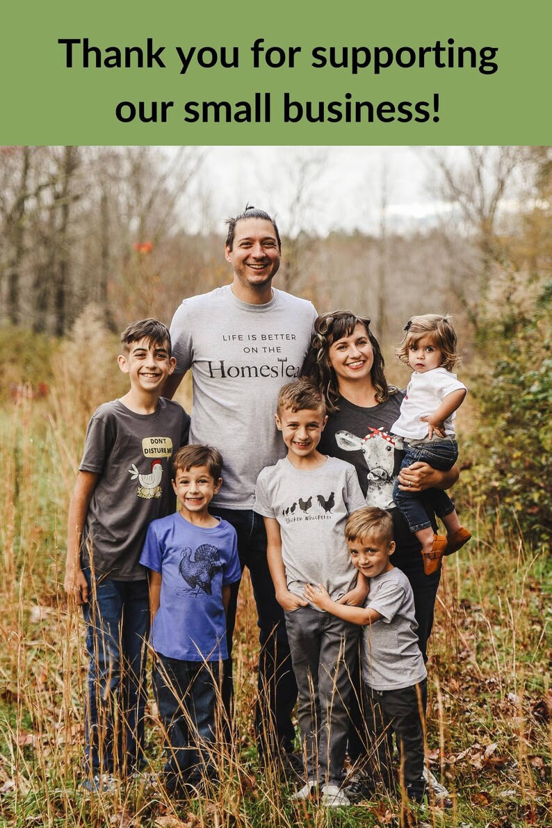 May include: A family of six, including two parents and four children, stand in a field of tall grass. They are all wearing t-shirts with various designs related to farm life. The shirts feature phrases like "Life is better on the homestead" and "Chicken Whisperer".