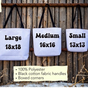 May include: Three white tote bags with black handles and black text. The bags are labelled "Large 18x18", "Medium 16x16", and "Small 13x13". The bags are made of 100% polyester with black cotton fabric handles and boxed corners.