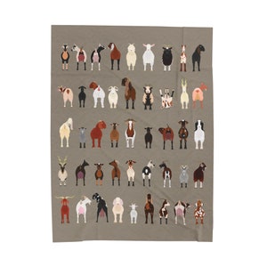 May include: A brown and tan fleece throw blanket featuring a pattern of 40 different goats in various poses. The goats are all facing forward and have different coloured coats, horns, and ears.