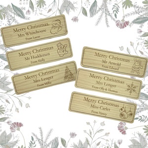 May include: Six wooden gift tags with a Christmas theme. Each tag has a different design and includes a name and a message. The tags are decorated with images of Santa Claus, a snowman, a Christmas tree, a snowflake, and Christmas ornaments.