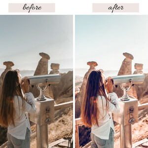 May include: A woman looks through a silver coin-operated telescope at a rocky landscape. The telescope is mounted on a metal stand. The woman is wearing a white shirt and blue jeans.