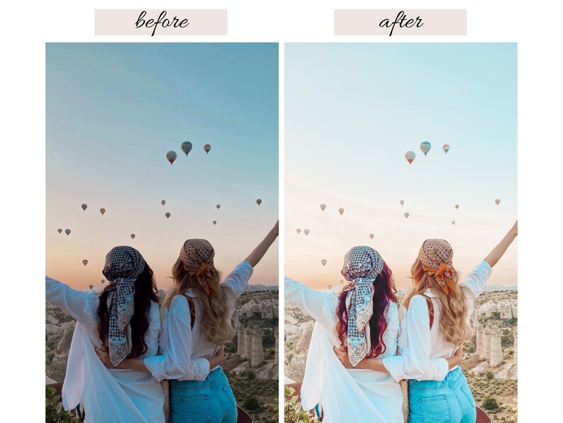 May include: Two people wearing white shirts and patterned head scarves stand with their arms raised in the air, looking at a field of hot air balloons in the sky. The sky is a light blue with a hint of pink in the distance.