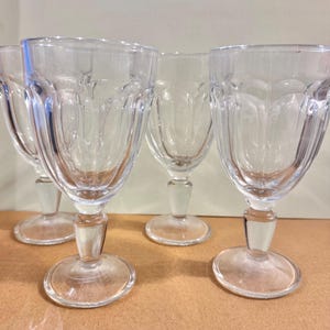 Set of 4 clear pressed glass goblets, decorative stemware.