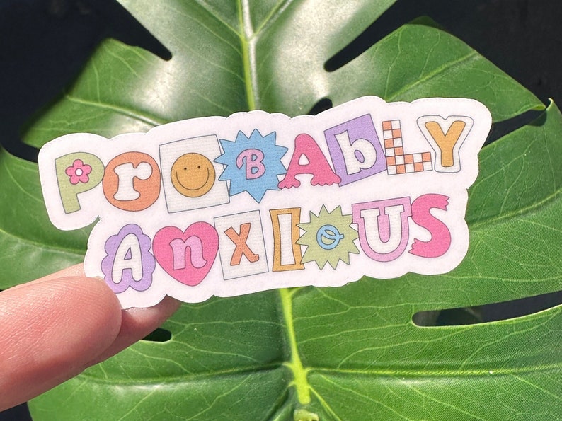 May include: A colorful sticker with the text "Probably Anxious" in a playful, cartoon font. The sticker is made up of individual letters and shapes, each with a different color and design.