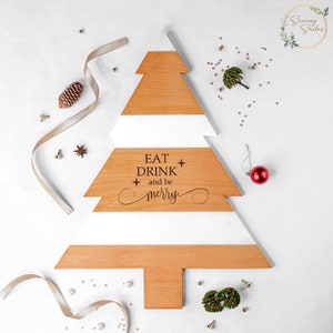 May include: White and brown wooden Christmas tree shaped serving tray with the text "EAT DRINK and be merry" engraved on the front.