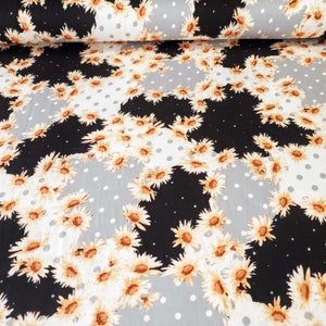 May include: Black and gray fabric with a white daisy pattern. The fabric has a polka dot pattern on the gray sections.