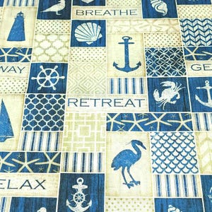 May include: A nautical-themed fabric with a patchwork design. The design features blue and white squares with images of anchors, seashells, sailboats, and lighthouses. The words "Breathe", "Retreat", and "Relax" are also visible. The fabric has a vintage, coastal aesthetic.
