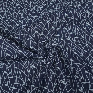 May include: Dark navy fabric with a white, delicate, leaf-like pattern. The design features intersecting lines and small, stylized leaf shapes, creating a textured and flowing visual effect. The fabric is slightly wrinkled.