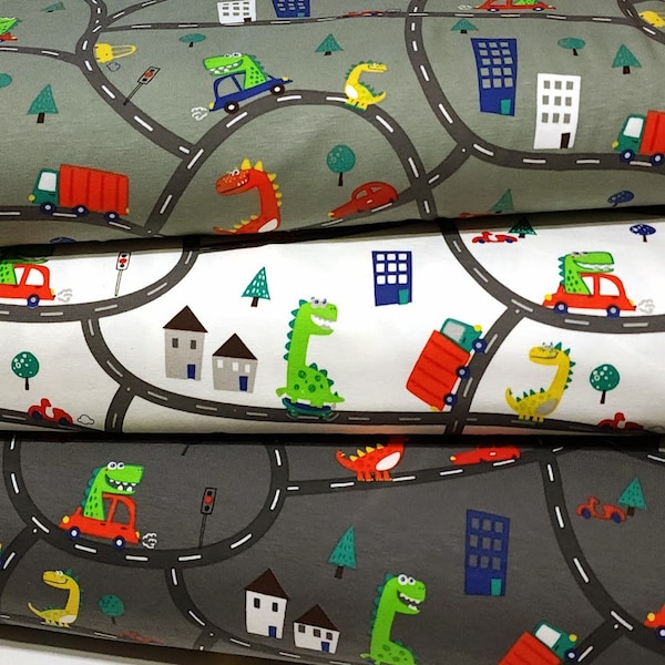 European Knit Fabric, Dinosaurs in the City in Trucks and Cars, 4-way stretch Cotton Spandex jersey knit, Sold by the 1/2 yard.