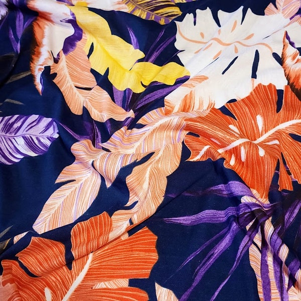 Cotton Jersey Knit  Fabric, Pretty Purple, Coral, and Yellow Tropical Print on Navy. 2-way stretch. Sold by the 1/2 yard