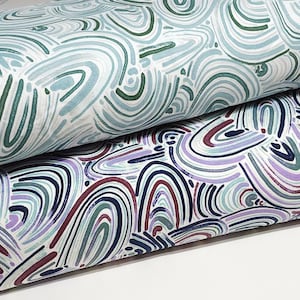 May include: Two pieces of fabric with a white background and a pattern of blue, green, and purple abstract lines resembling rainbows.