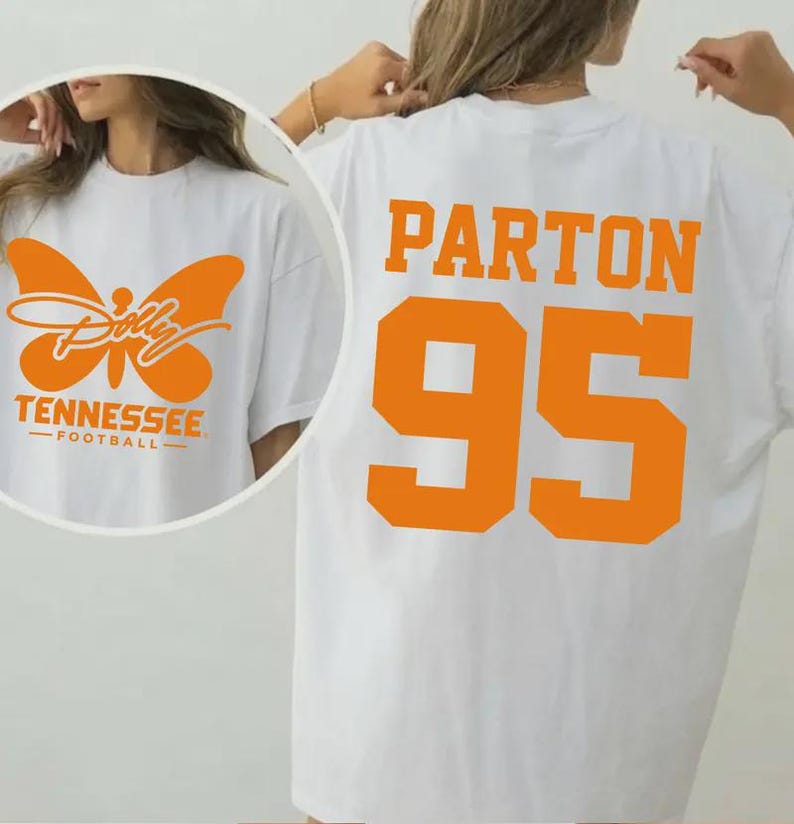 May include: A white t-shirt featuring orange graphics. The back displays the text PARTON and the number 95 in a large varsity font. The front, shown in a circular inset, features an orange butterfly graphic with the text Dolly, TENNESSEE, FOOTBALL.