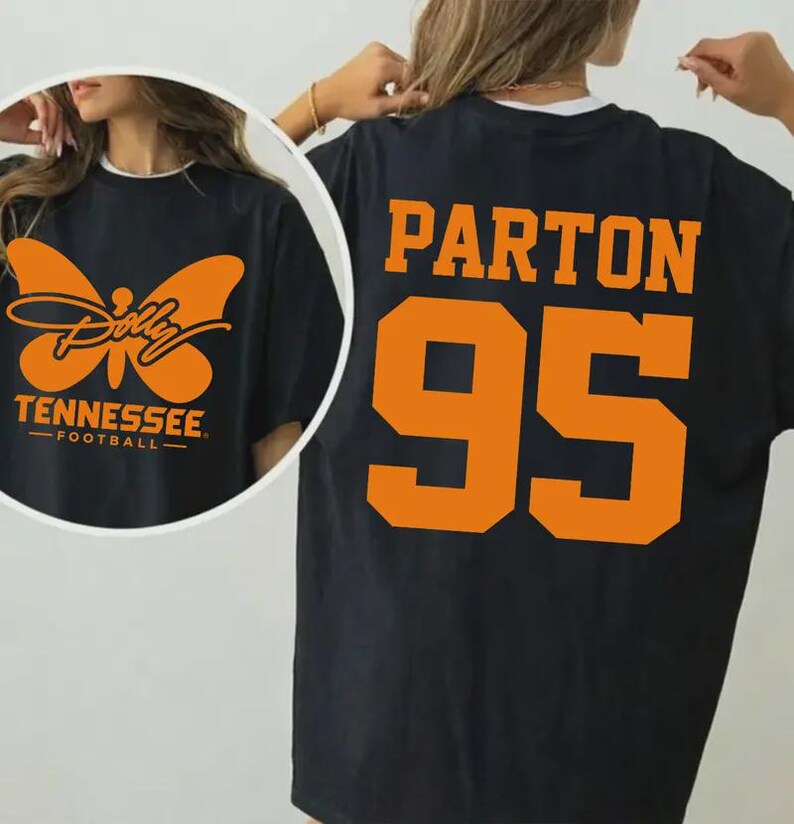 May include: A black t-shirt featuring an orange graphic of a butterfly with the text Dolly Tennessee Football on the front and the orange text Parton 95 on the back. The design uses a bold, athletic font for the number and name on the back.