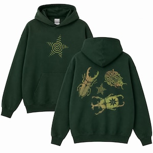 May include: A dark forest green hooded sweatshirt featuring a front graphic of a yellow spiral star. The back of the hoodie displays three detailed beetle illustrations in shades of yellow and green, accompanied by a small spiral star graphic.