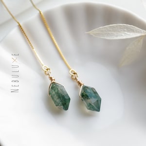 May include: A pair of gold chain earrings with green moss agate teardrop-shaped pendants.