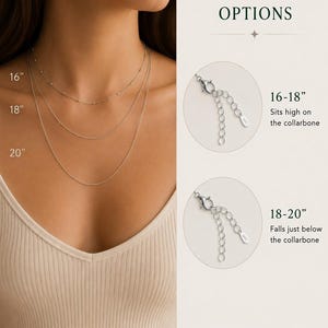 May include: A silver-toned chain necklace shown in three lengths: 16 inches, 18 inches, and 20 inches. The image includes text labels for chain length options, showing 16-18 inch and 18-20 inch adjustable clasps with extender chains.
