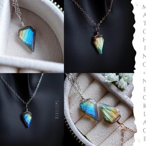 May include: A collection of necklaces with iridescent, geometric pendants. The pendants display a spectrum of colors, including blues, greens, and yellows. The necklaces are displayed on a neutral background, with the text "MATCHING NECKLACE" visible.