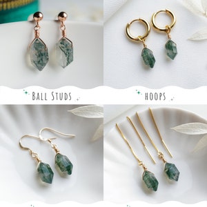 May include: Four different styles of earrings featuring green moss agate stones. The styles include ball studs, hoops, hooks, and threaders.