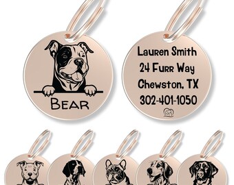May include: A collection of round, rose gold-toned metal pet ID tags featuring black laser-engraved illustrations of various dog breeds peeking over a horizontal line. Each tag includes a name and a split ring. One tag shows contact information.