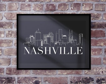 以下が含まれることがあります： ナッシュビルのスカイラインの白黒プリント。スカイラインの下に白い文字で「NASHVILLE」と書いてあります。