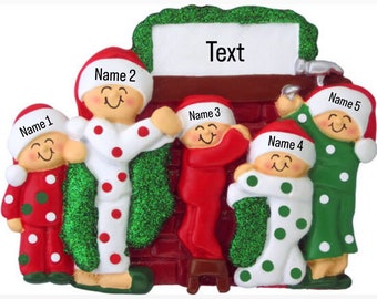 May include: A Christmas ornament featuring five figures in pajamas climbing down a chimney. The ornament is decorated with green, red, and white colors. The text "Text" is on the chimney.