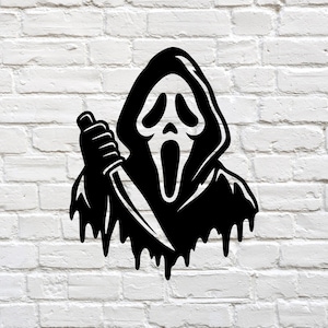 May include: A black graphic decal featuring a stylized hooded figure with a long, pointed mask and an open, screaming mouth. The figure is holding a sharp knife in one hand, and the bottom edge of the cloak has a dripping, liquid-like effect.