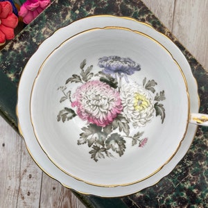 Paragon imperfect pale blue with floating pink, white purple chrysanthemum double warrant tea cup and saucer set. Vintage bone china England
