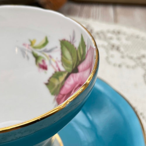 Aynsley turquoise corset shape with large cabbage rose tea cup shops and saucer set. Vintage bone china England