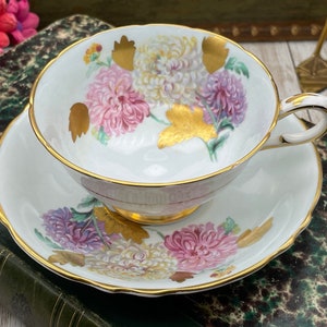 Paragon pale blue with chrysanthemums and gold leaves double warrant tea cup and saucer set. Vintage bone china England